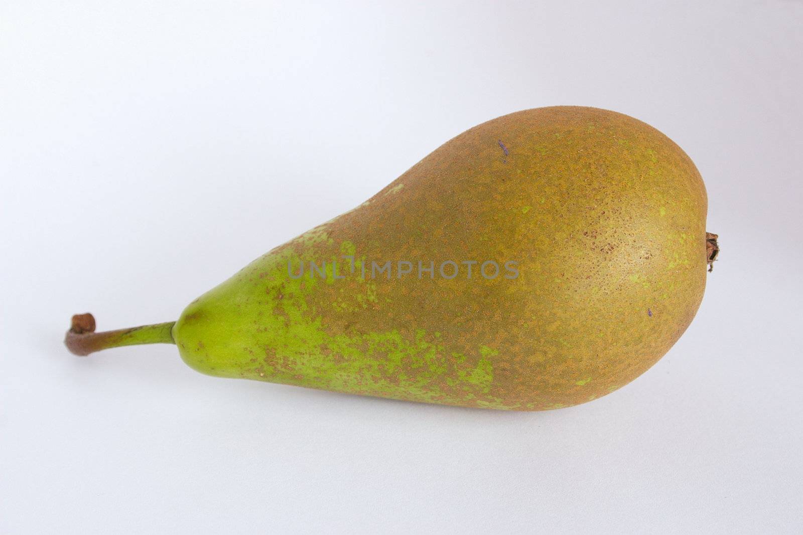 whole fresh conference pear against a light background