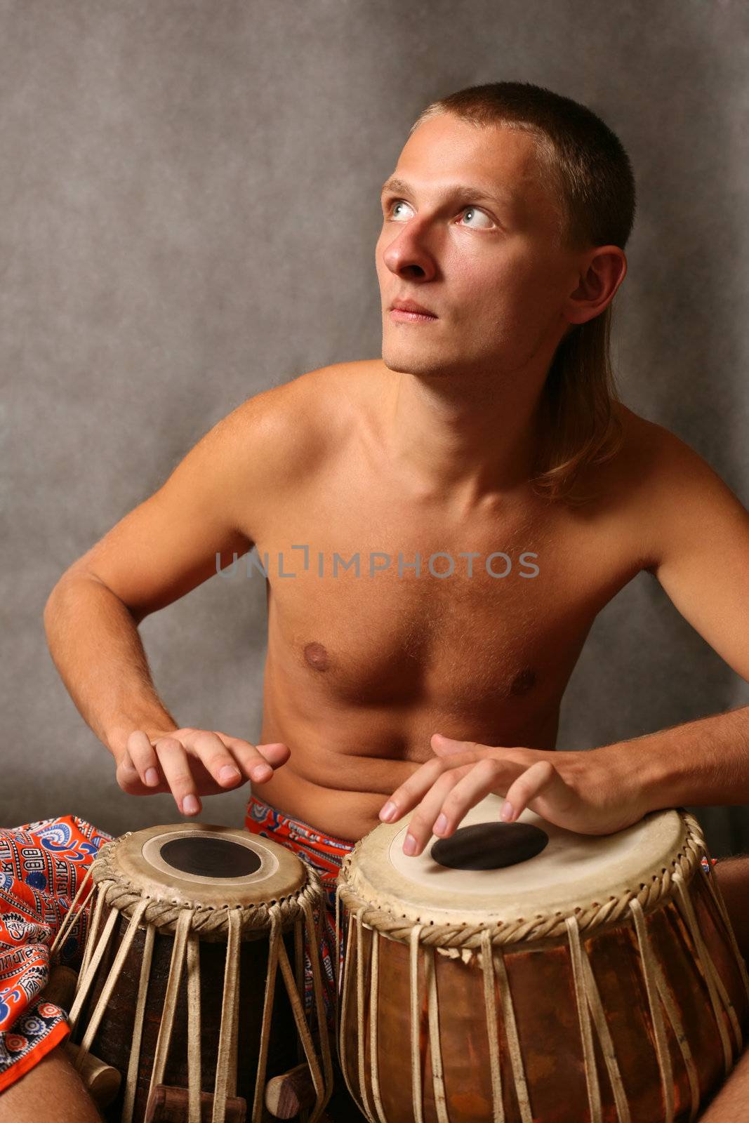 Man playing the nigerian drum in studio