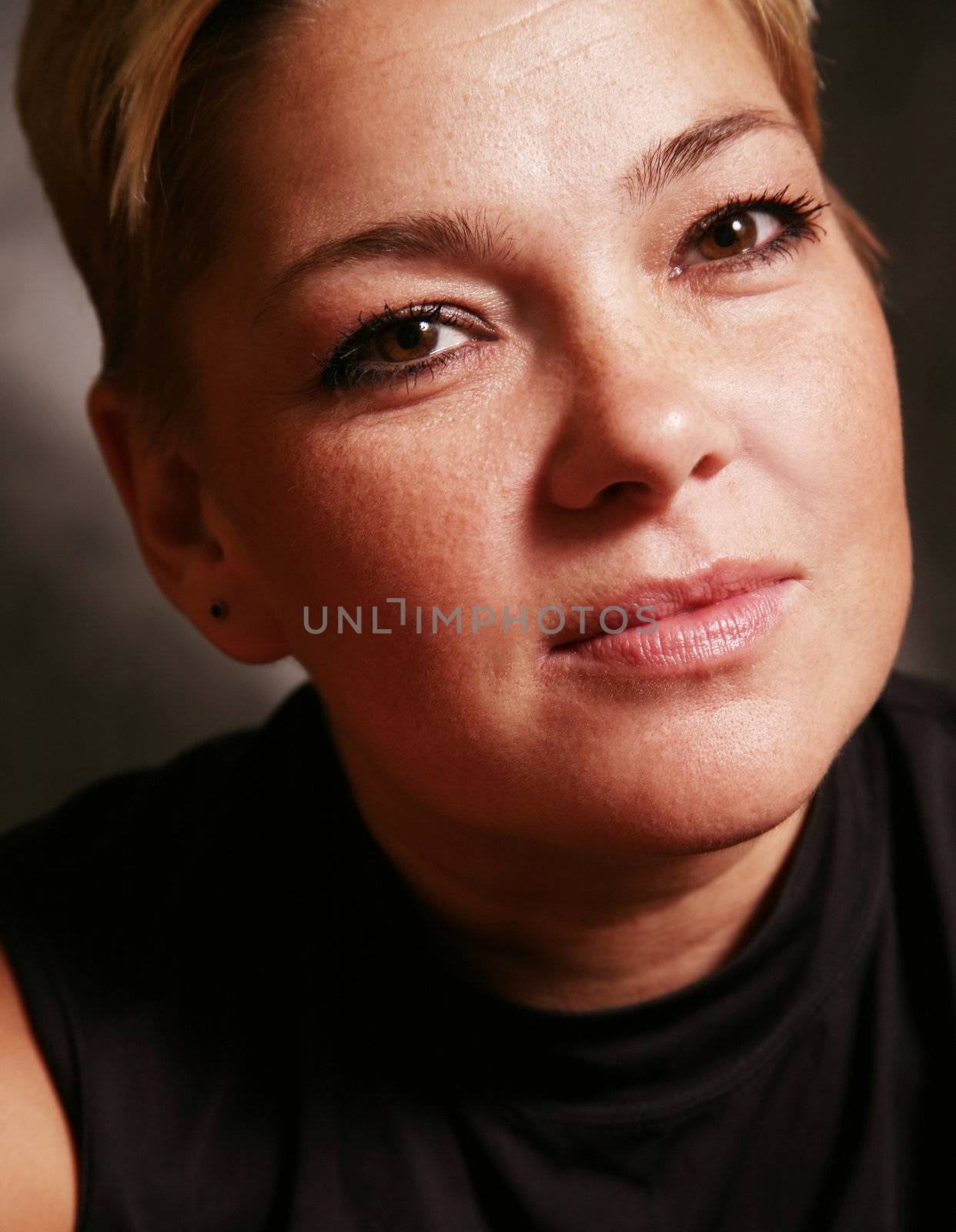 Portrait of the adult woman close-up in studio