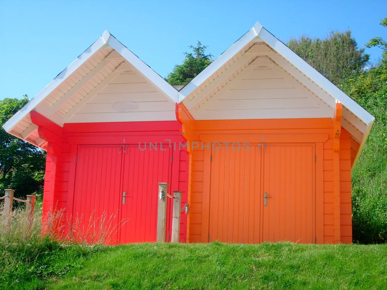 Exteriors of beautiful bright seaside beach chalets, Scarborough, England.