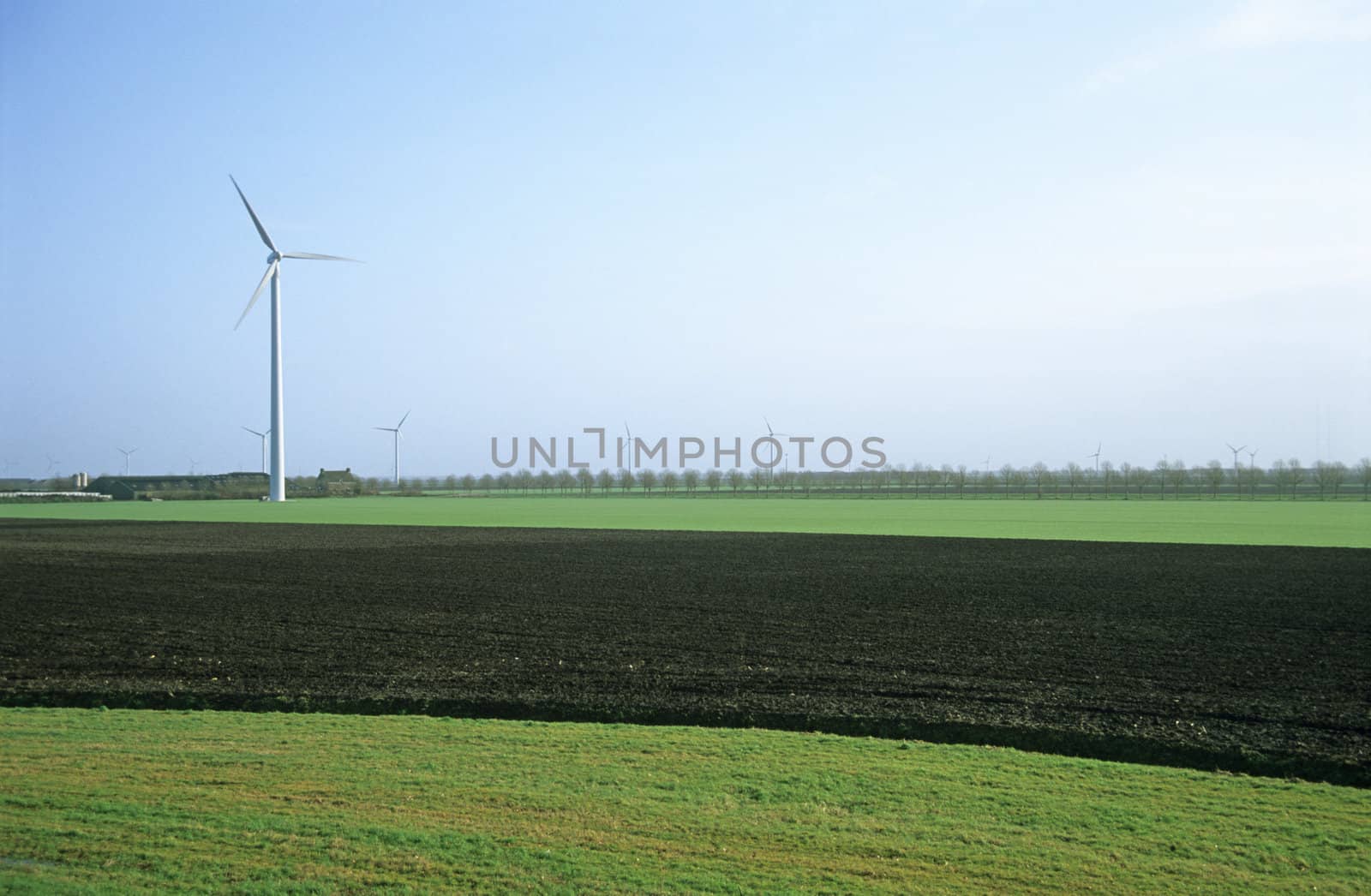 Modern windmills, or wind turbines, dot the lowland countryside of the Netherlands.