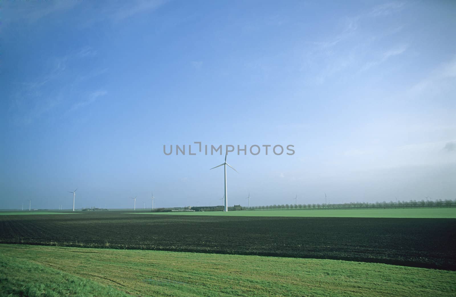 Large modern windmills on a farm in the Netherlands.