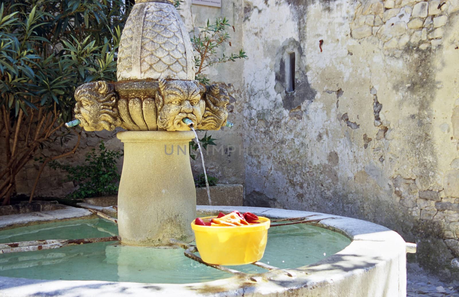 Laundry being washed in a fountain in a rural village, Provence, France.