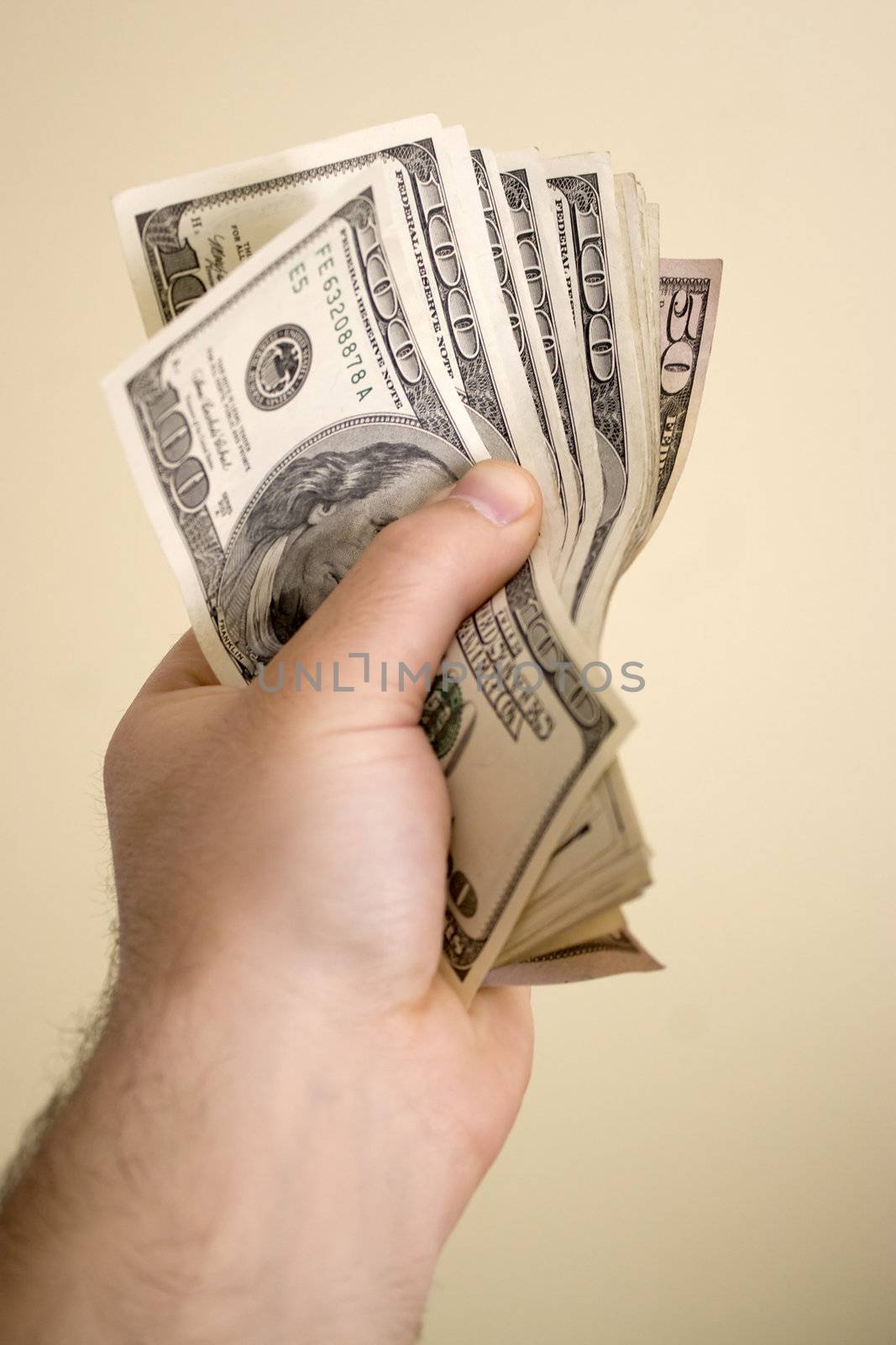 A handful of cash isolated over a solid background.