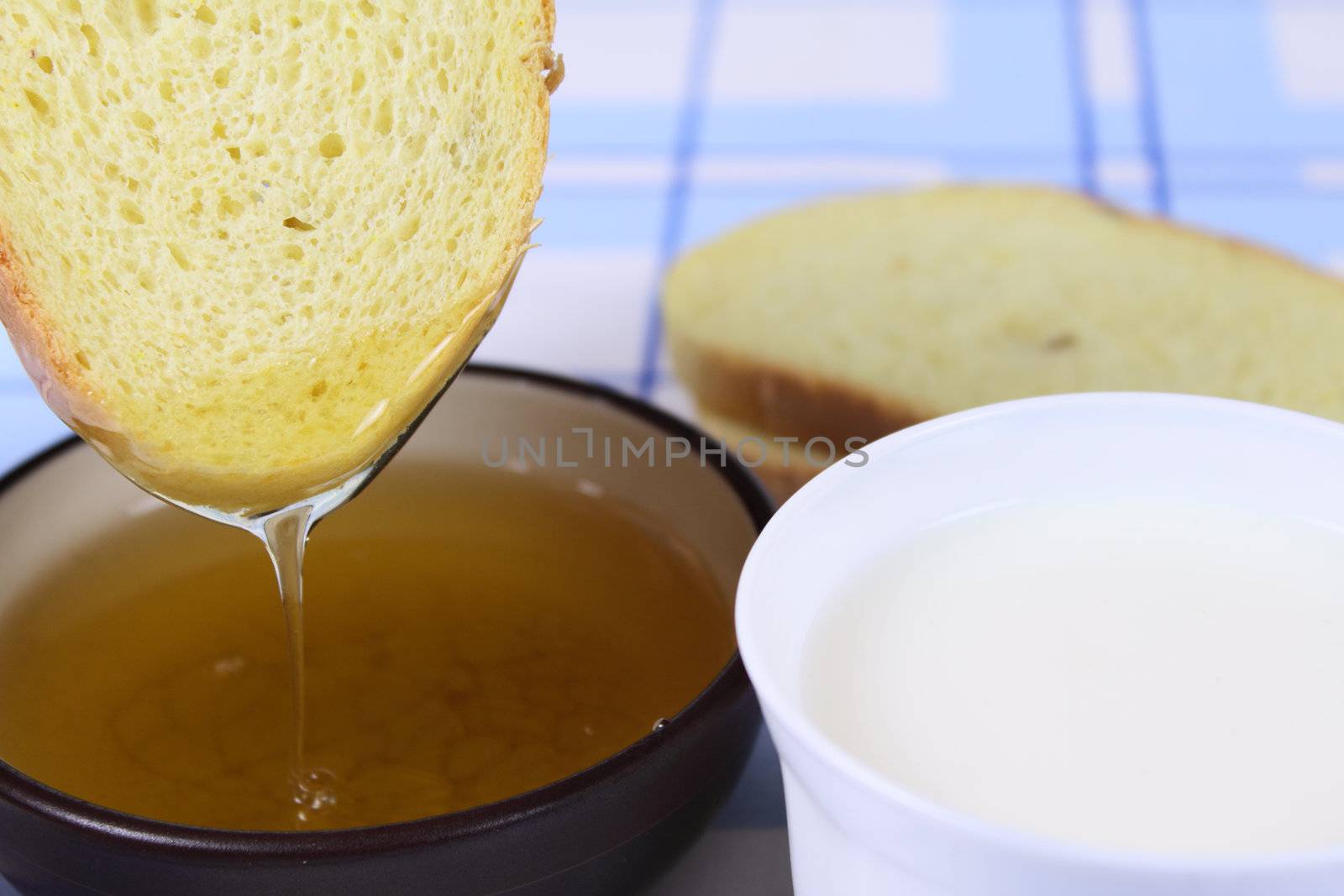 Cornbread with honey and milk on a linen blue napkin removed close up