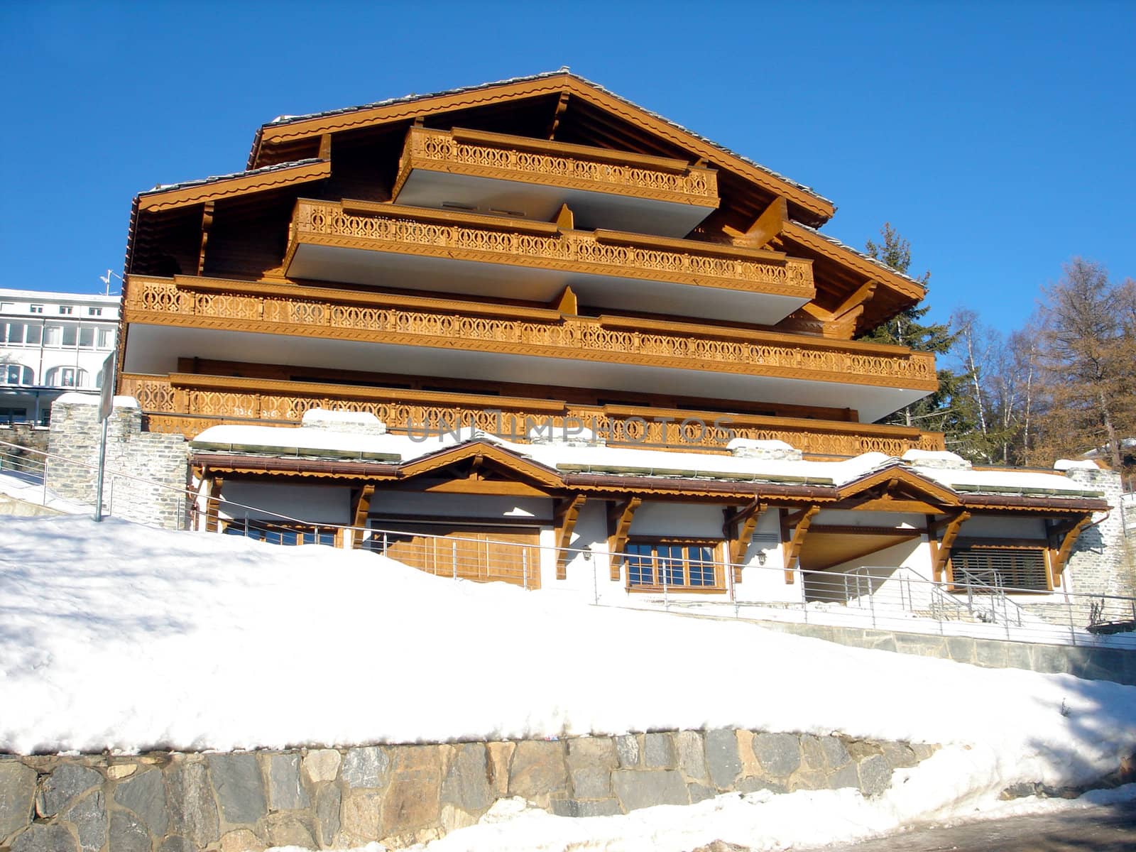 Exterior architecture of Swiss Ski chalety in winter snow.