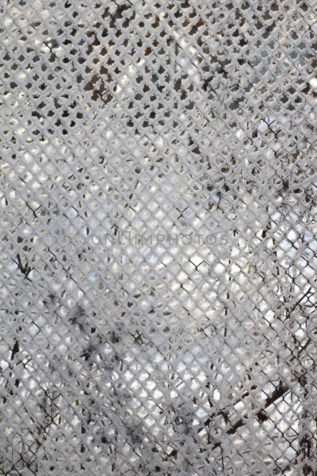 Metal grid covered by a snow removed close up