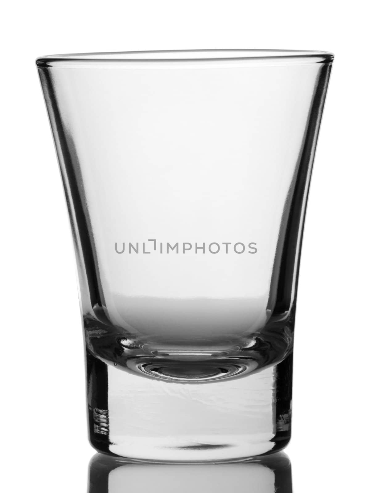 An empty shot glass on white background.