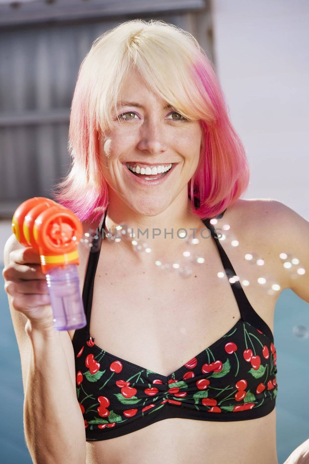 Woman in bikini with a bubble gun
