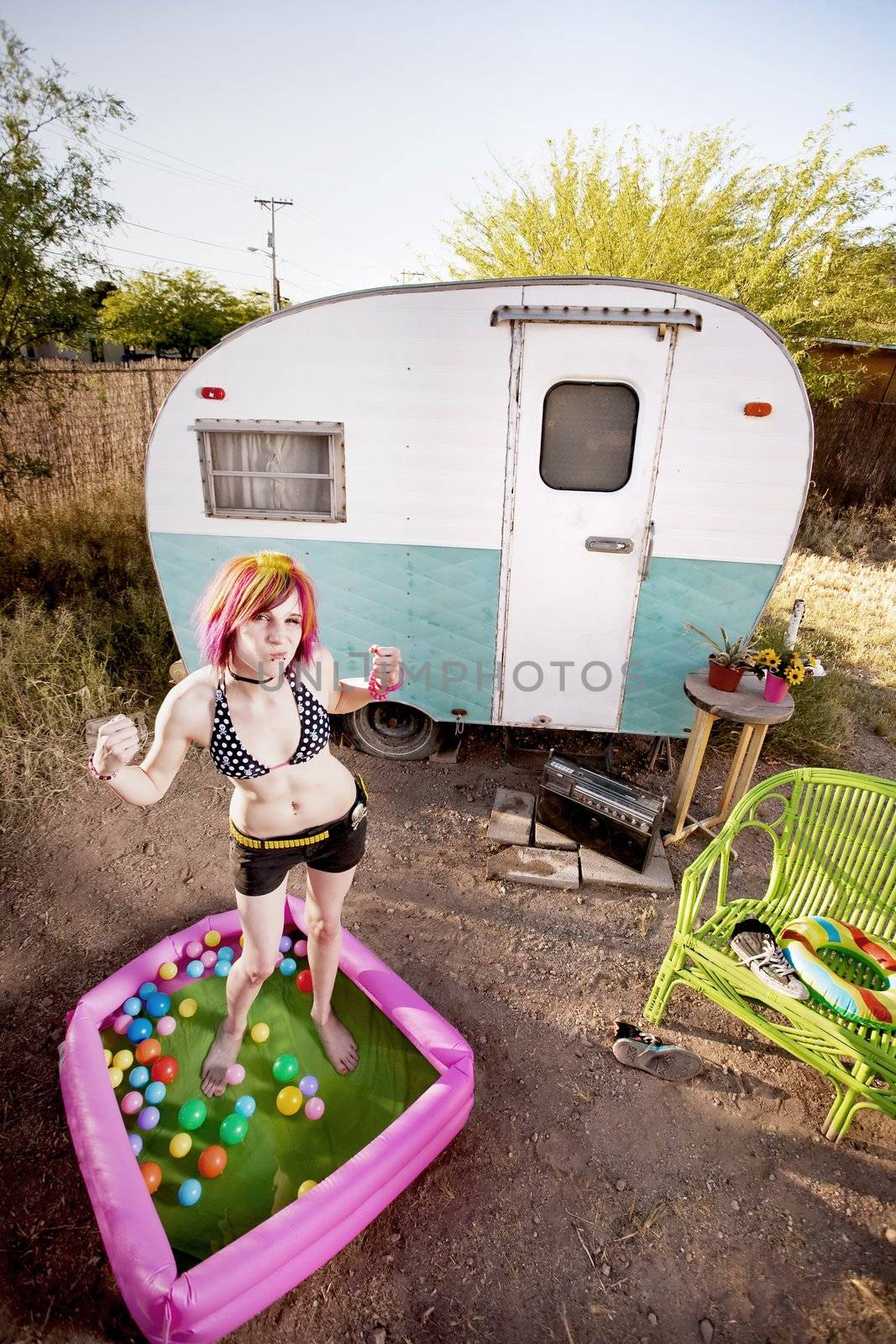 Woman flexing in a play pool by Creatista