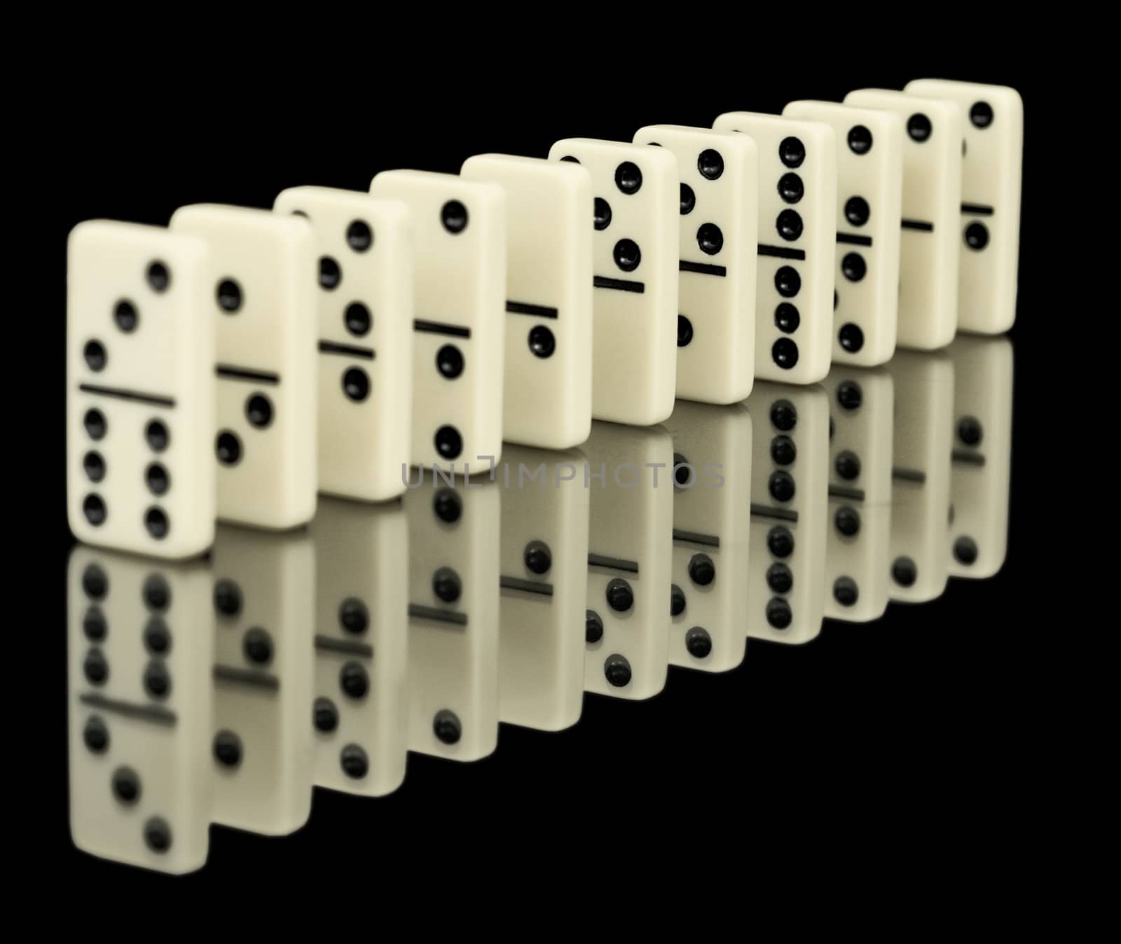 Chips dominoes ranked on a black background with reflection