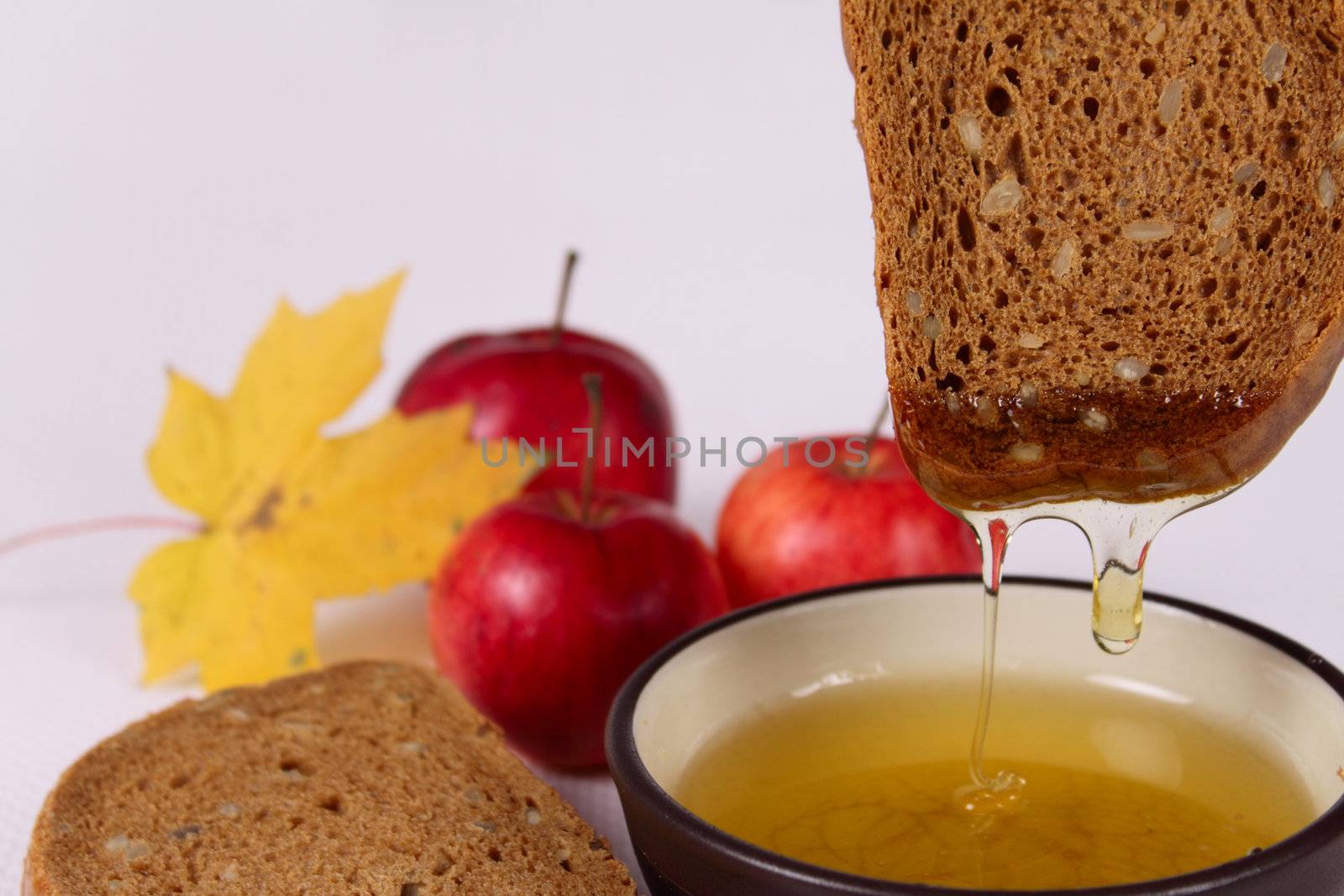 Bread, honey and apples removed close up on a linen napkin