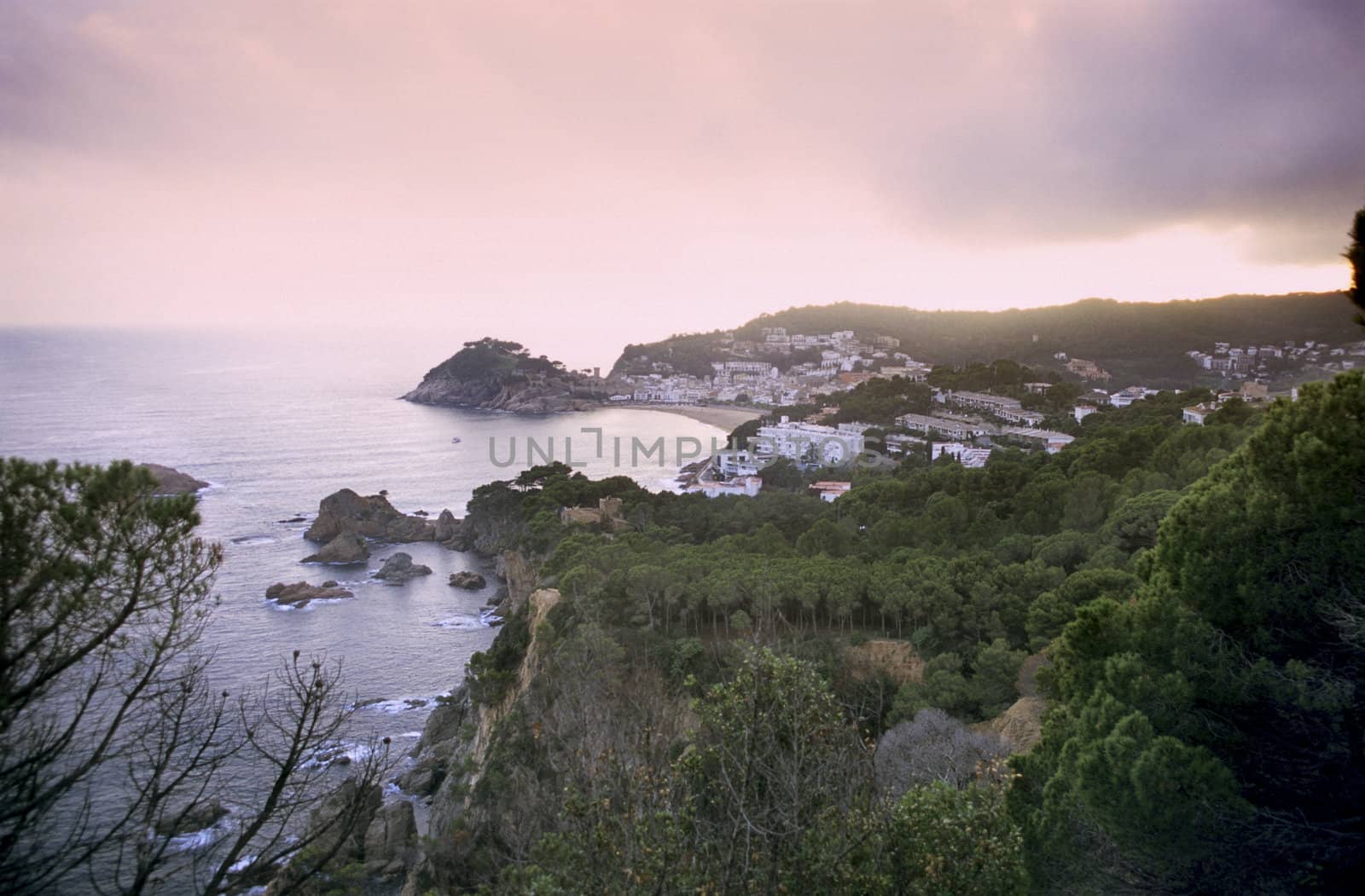 The sun sets over a resort town on Spain's Costa Brava.