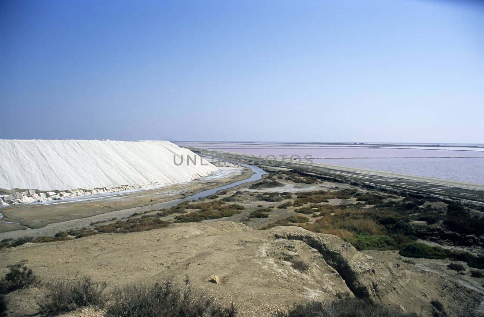 Mountain of salt piled and drying in the sun, salt flats, Salin de Giraud, Camargue, France. 