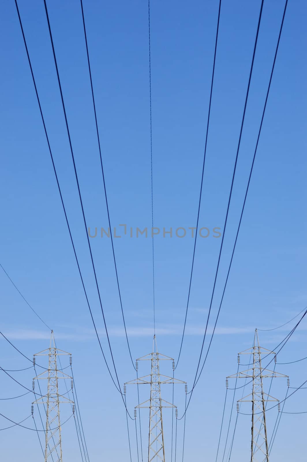 Three pylons with power lines stretching from them
