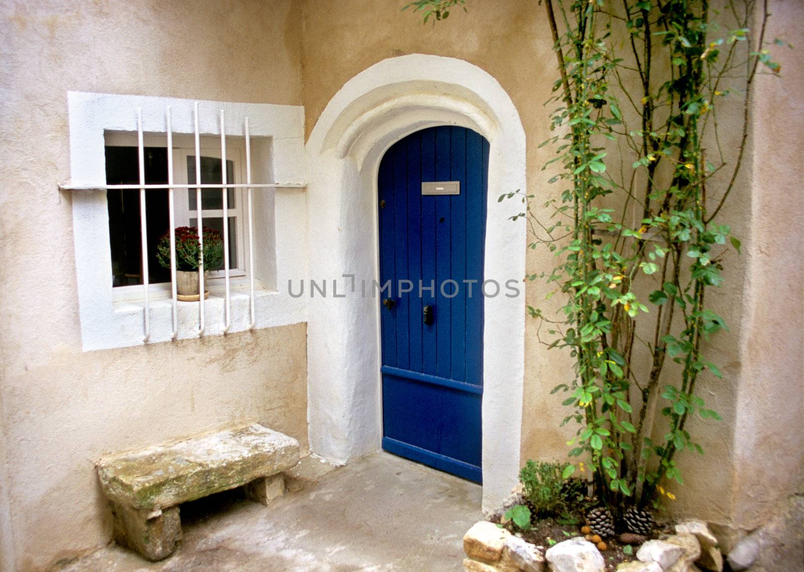 A bright blue door welcomes visitors to a home in the provence region of France.