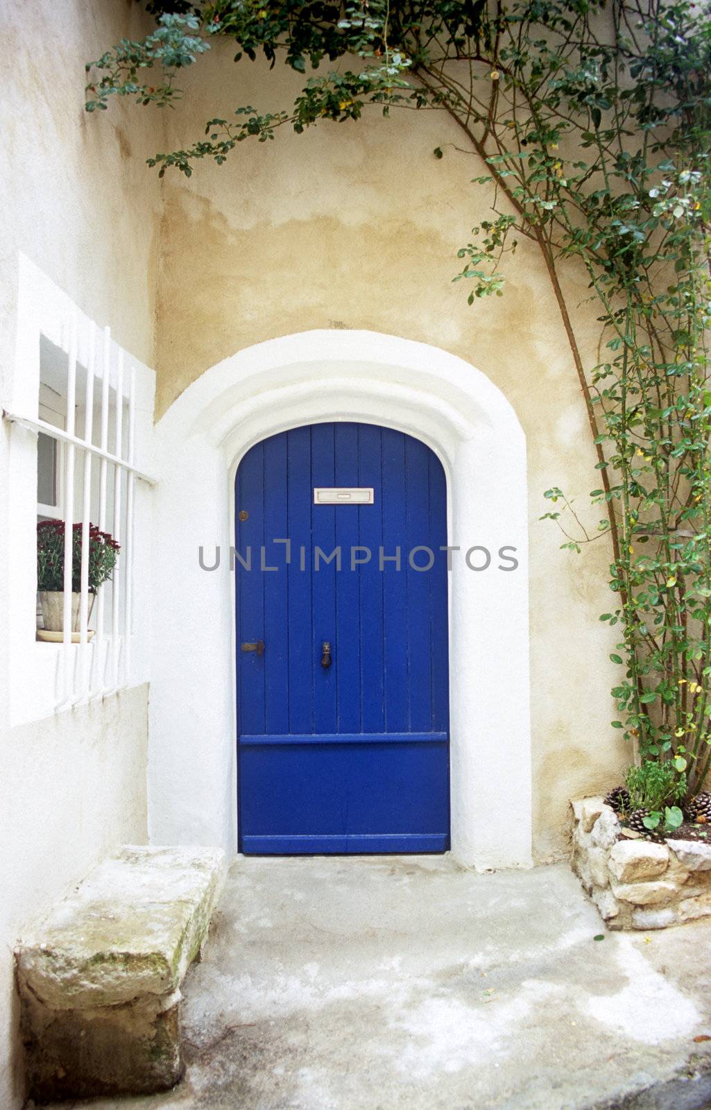 A bright blue door welcomes visitors to a home in the provence region of France.