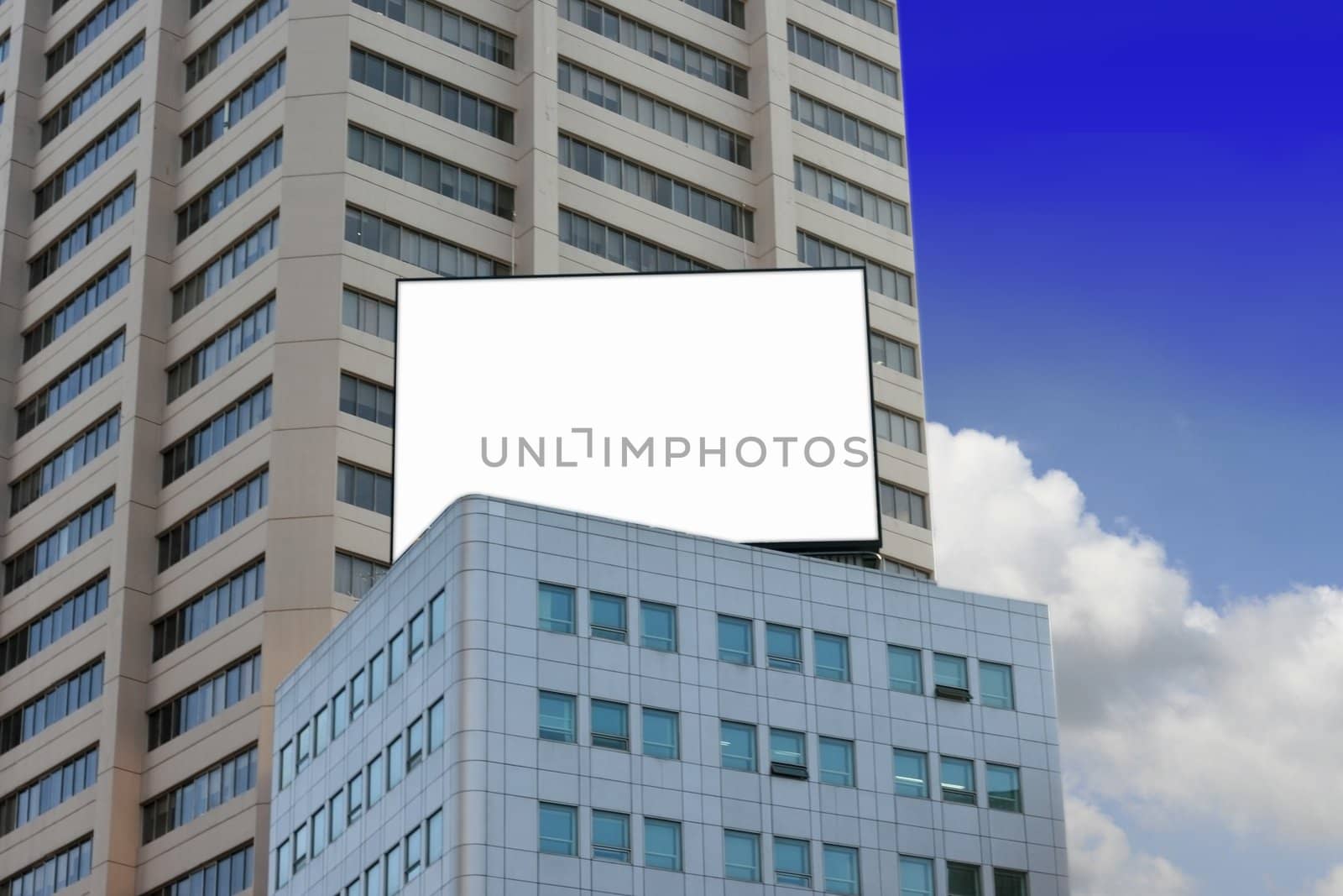 Blank billboard on top of building with blue sky