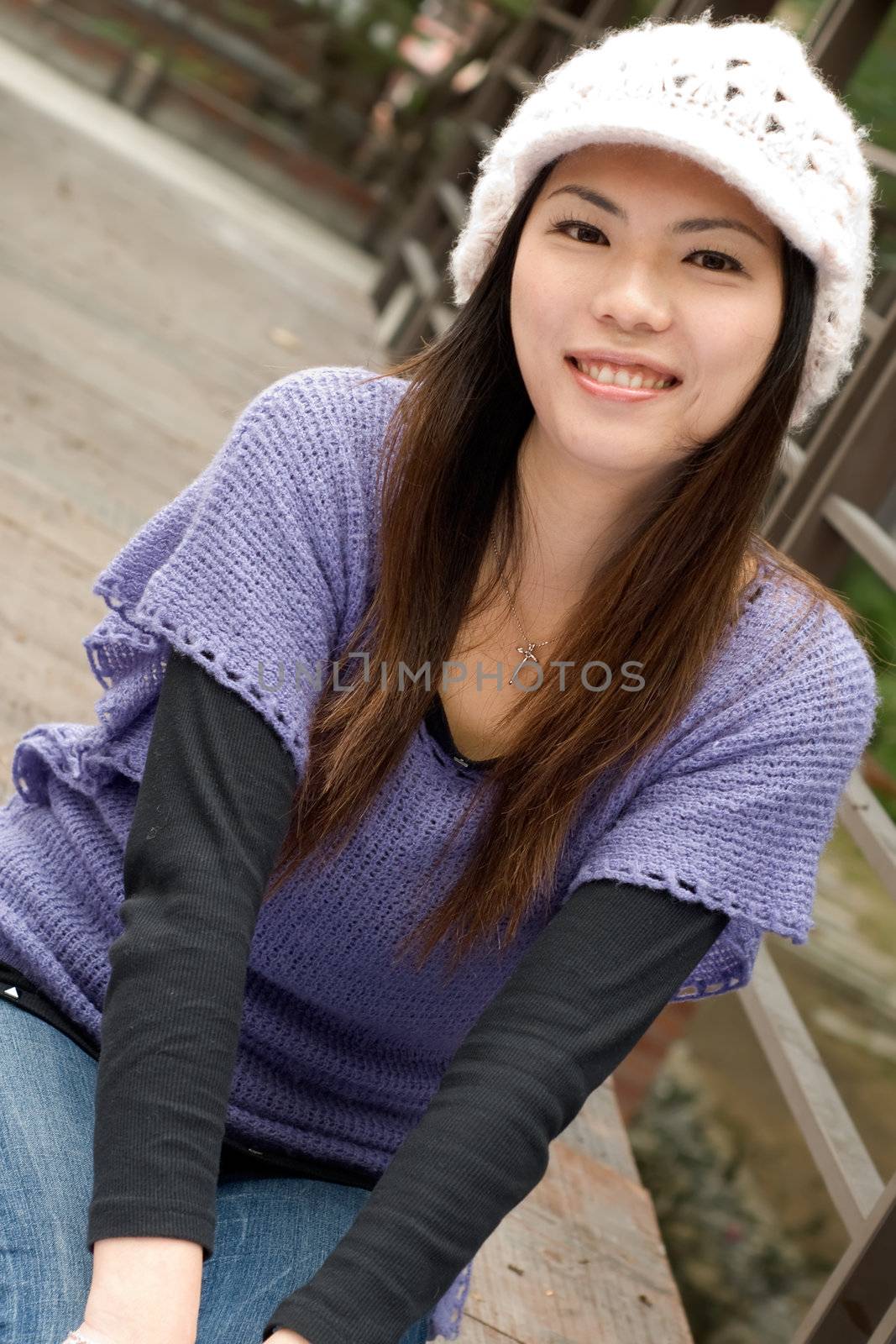 Happy smile Asian beauty sit in park.