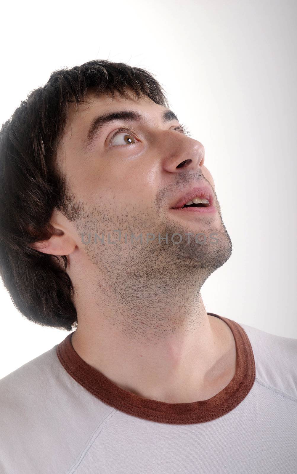 Surprised young man on white background