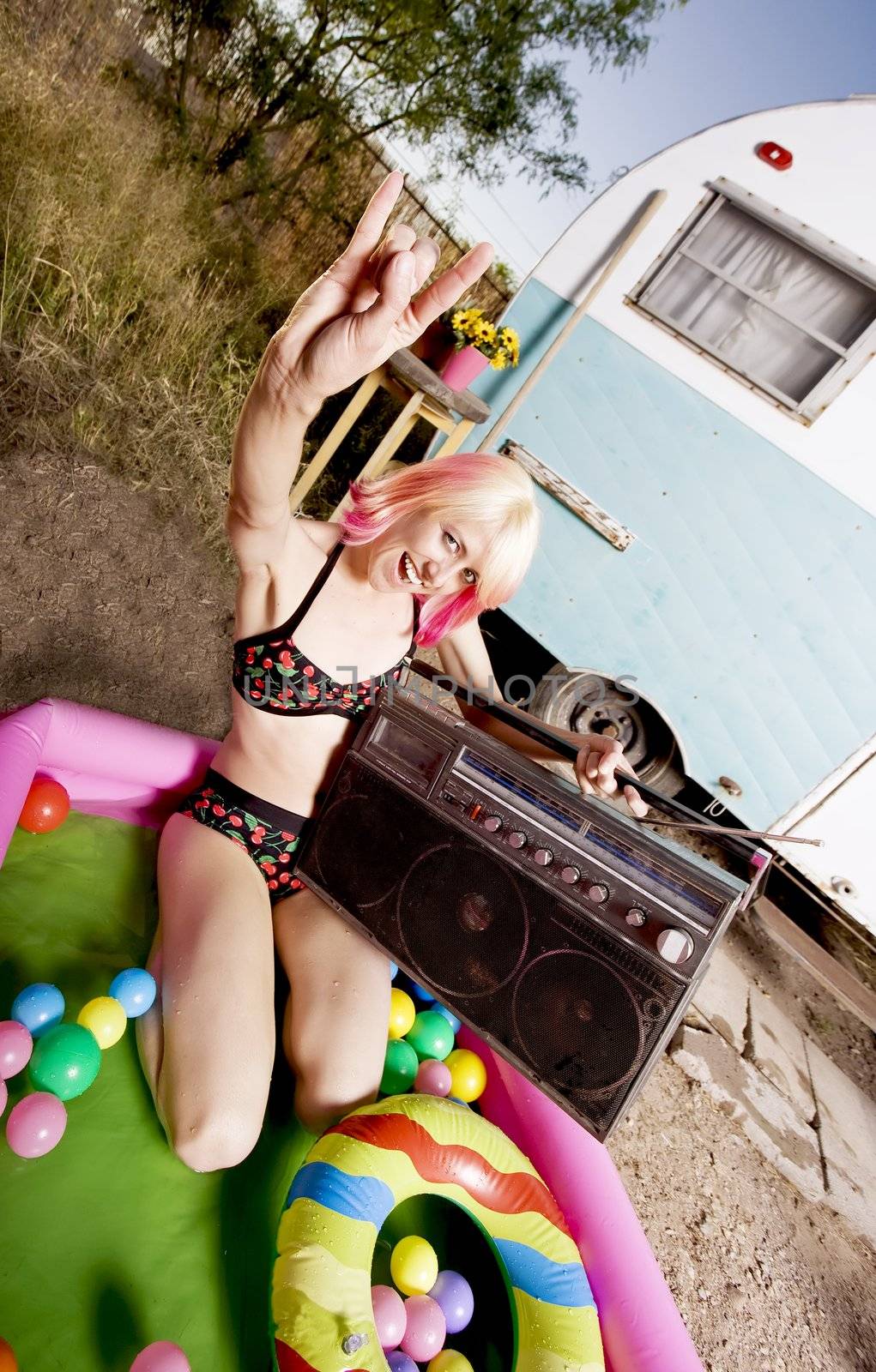 Woman with a boom box in an inflatable play pool