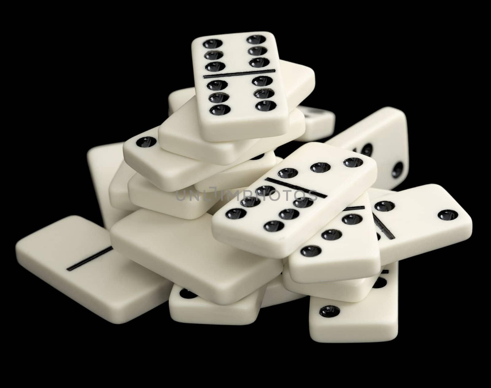 A large heap of dominoes isolated on a black background