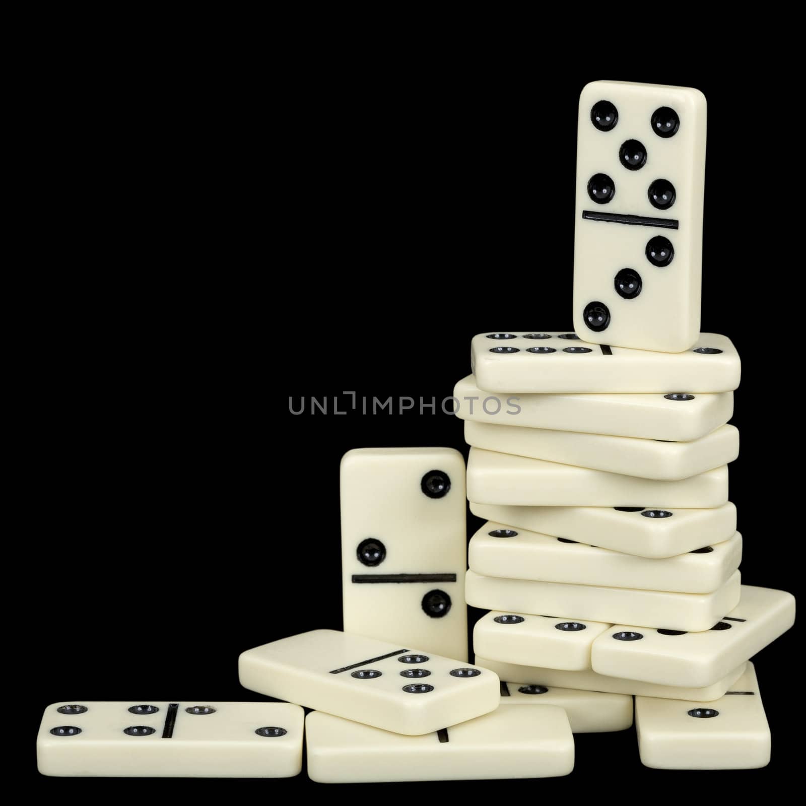 A large pile of dominoes isolated on a black background