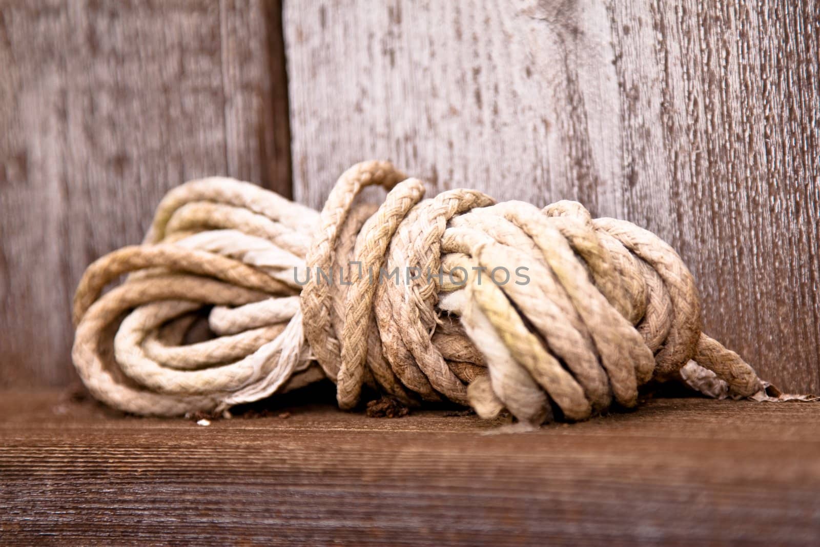 Ball of white twine cord on wooden ledge