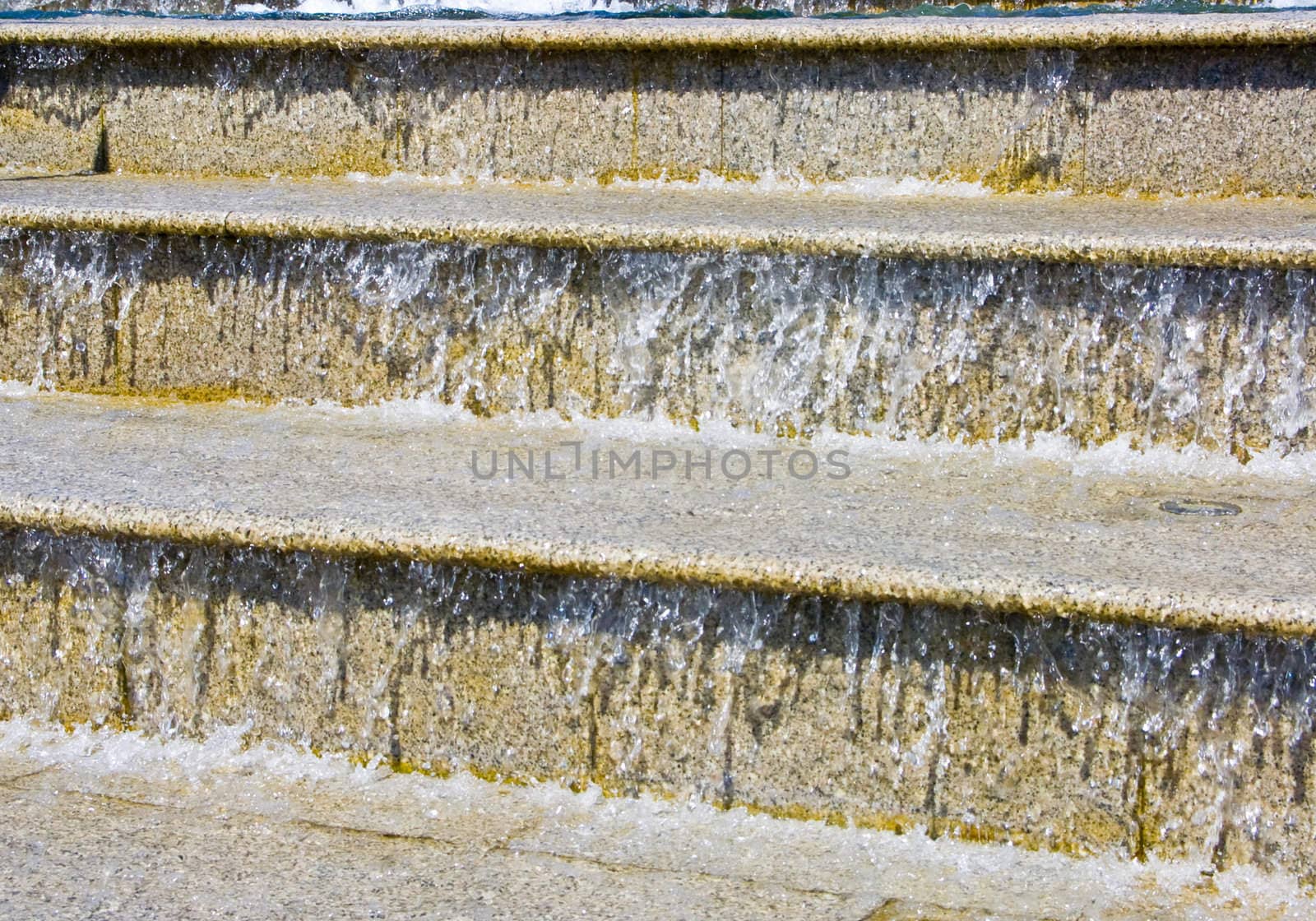 The image of a cascade fountain - steps on which runs water.