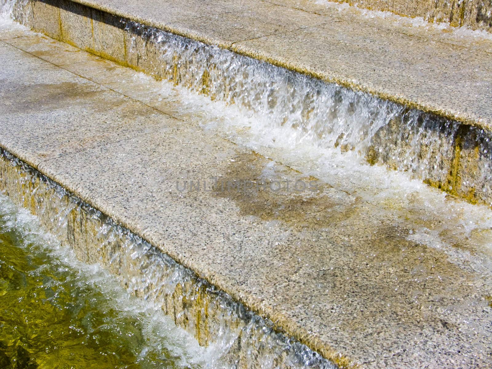 The image of a cascade fountain - steps on which runs water.