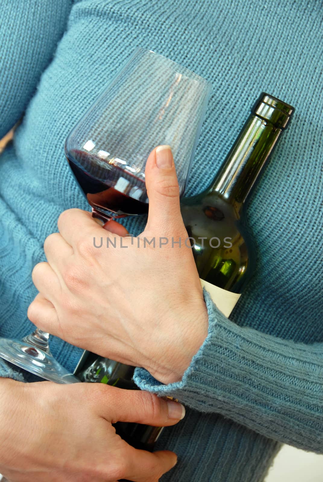 wine glass and bottle in woman's hug