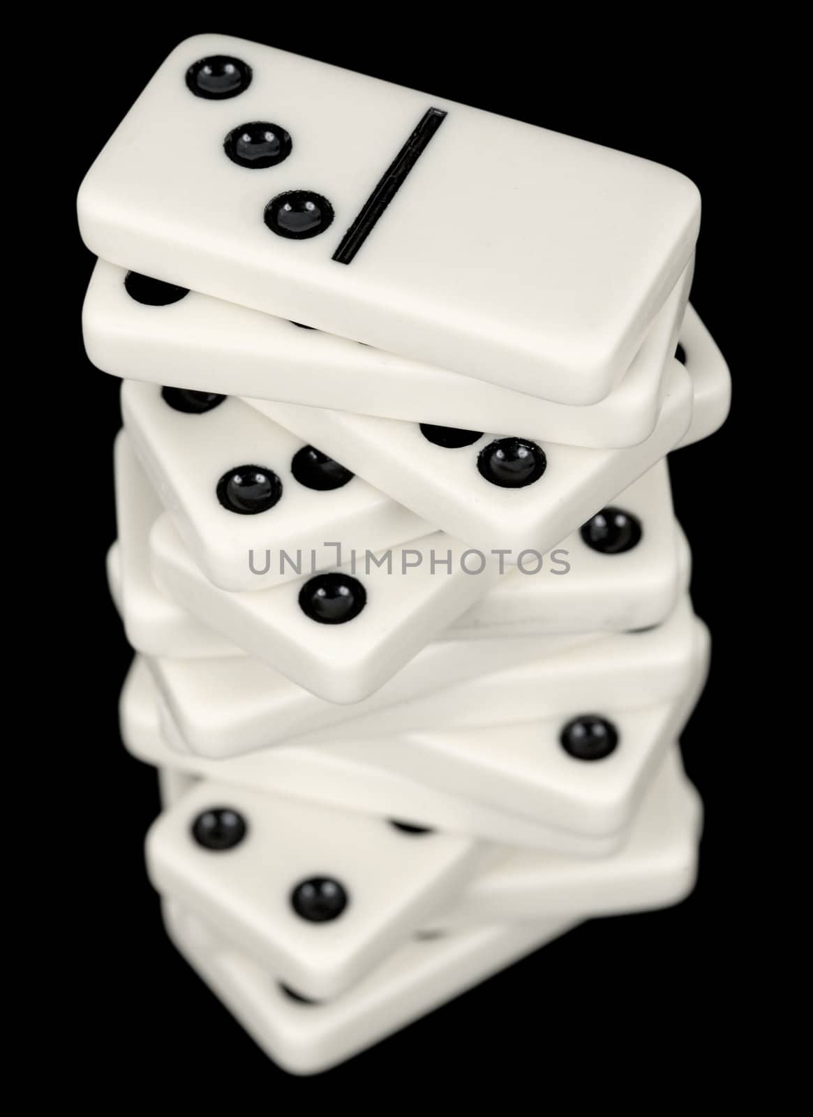 A stack of dominoes isolated on a black background