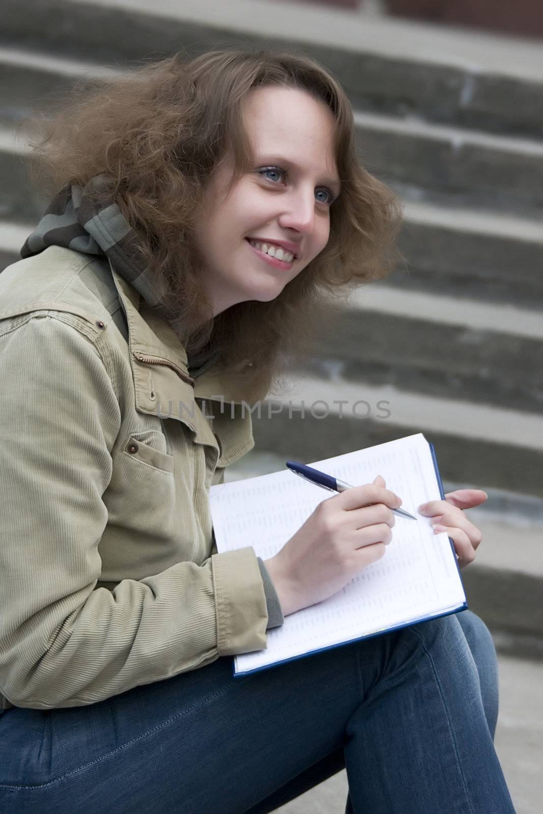 Yong girl siting with their notebook.