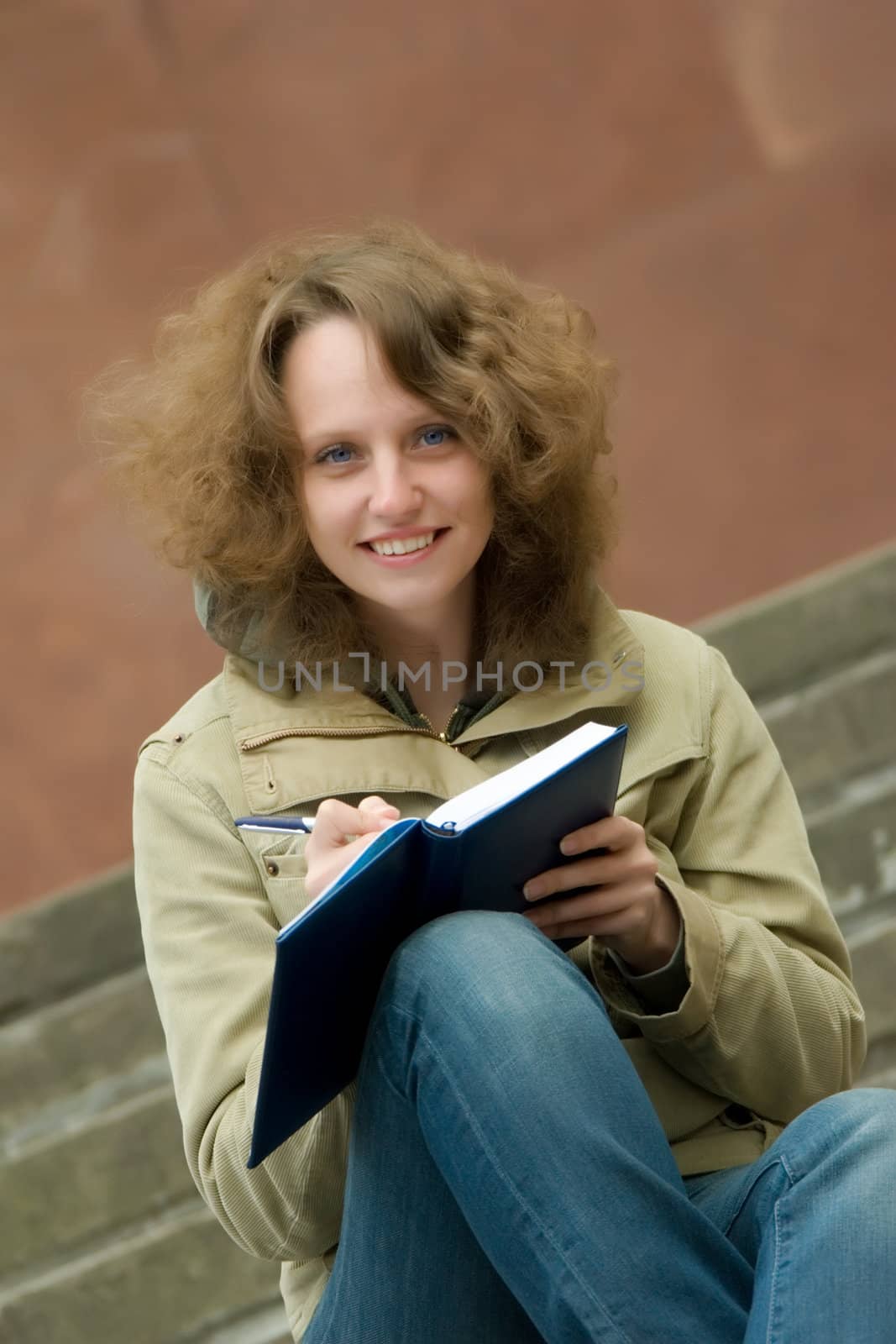 Smiling student with copy-book.