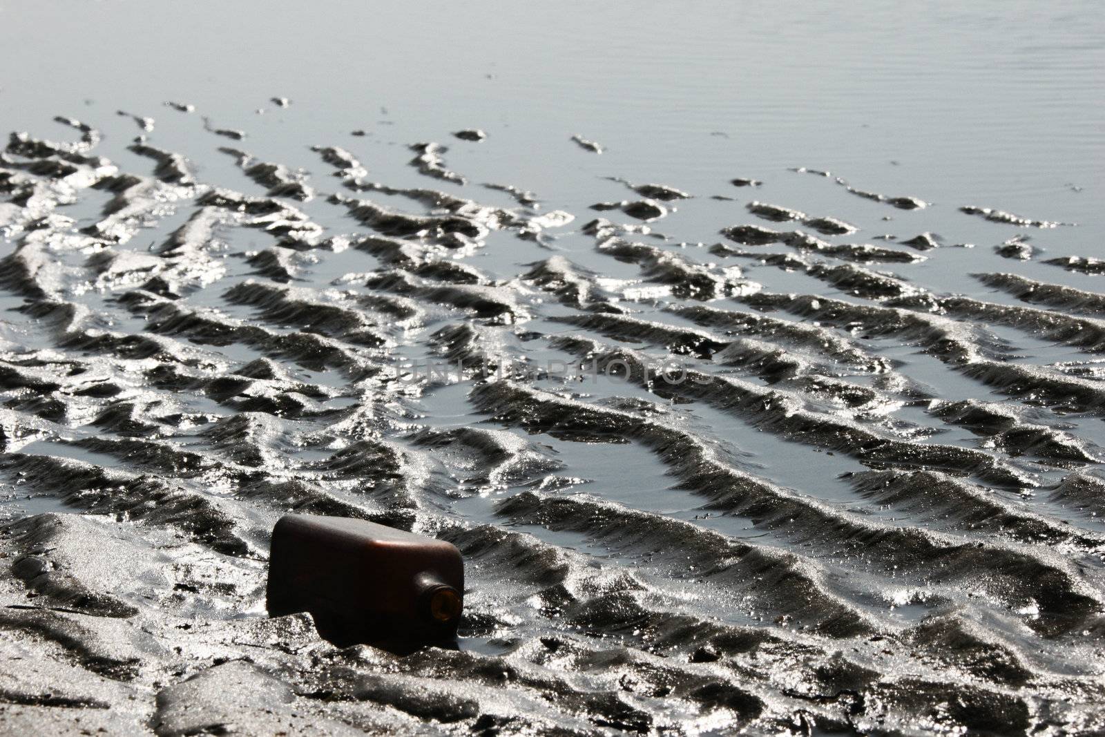 Empty bottle on sea coast.
