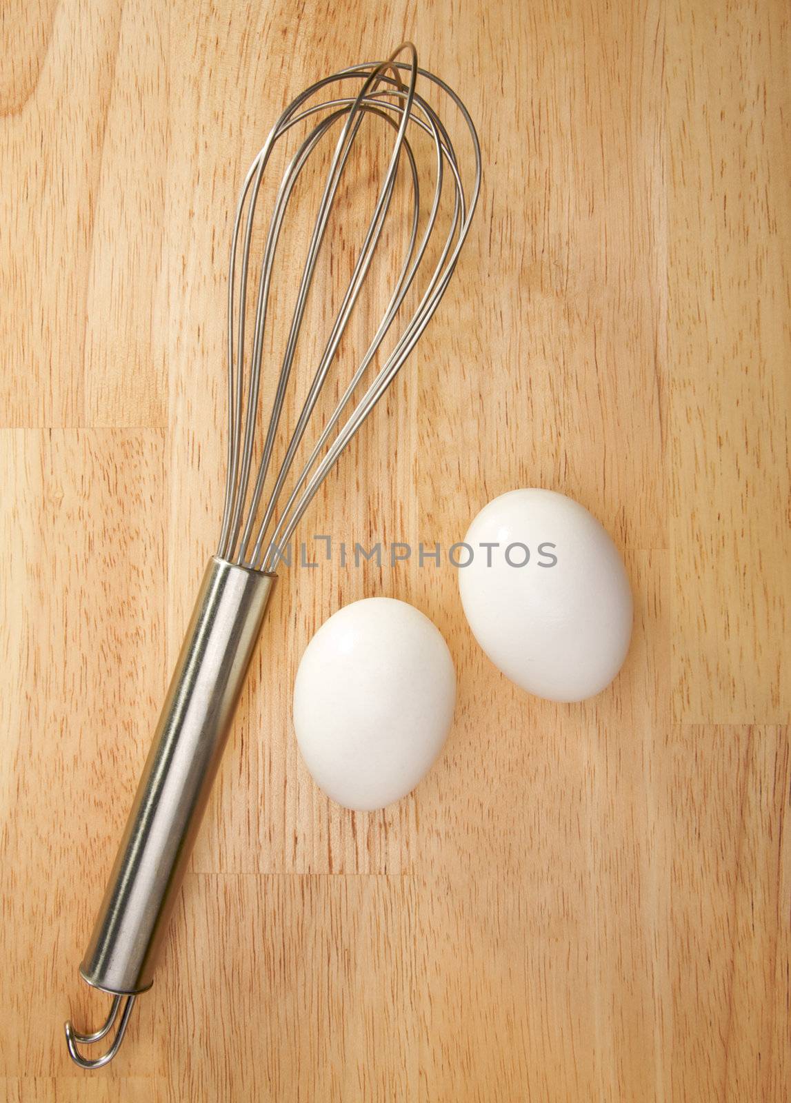 Mixer and Eggs on a wooden background.