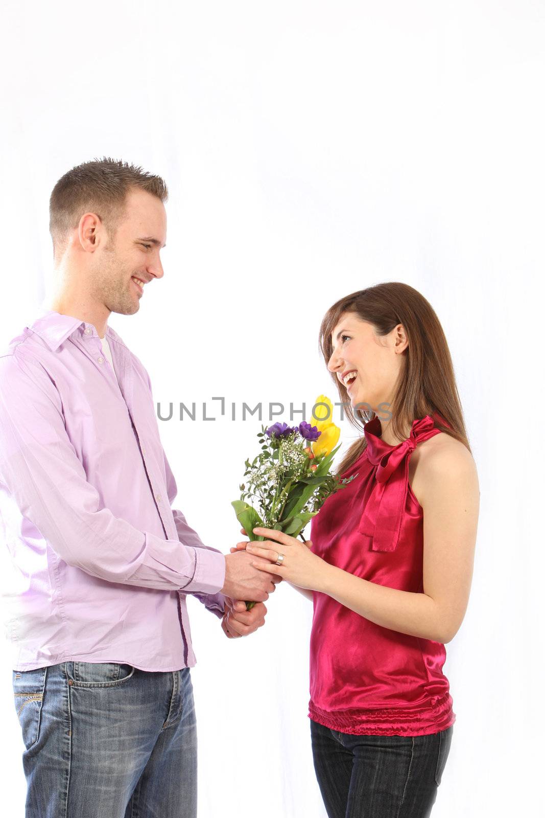 Young, happy couple. The man handed the woman a bouquet of flowers