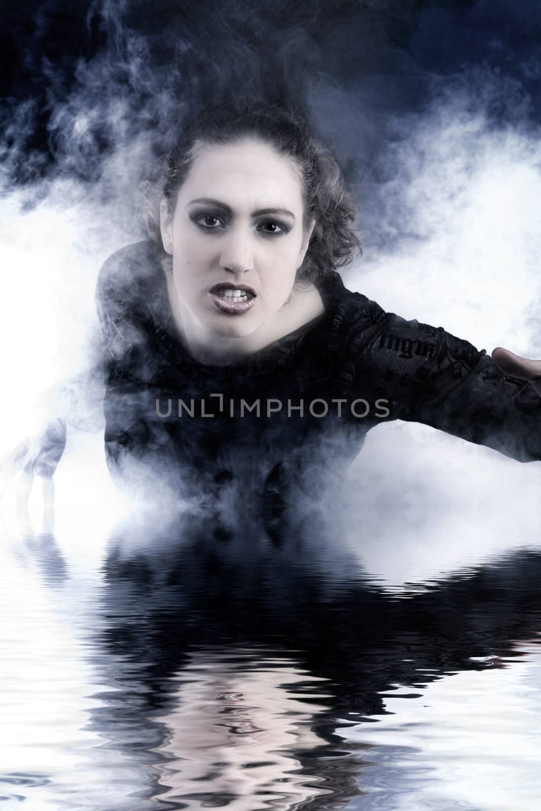 Portrait of a woman with long curly hair in smoke