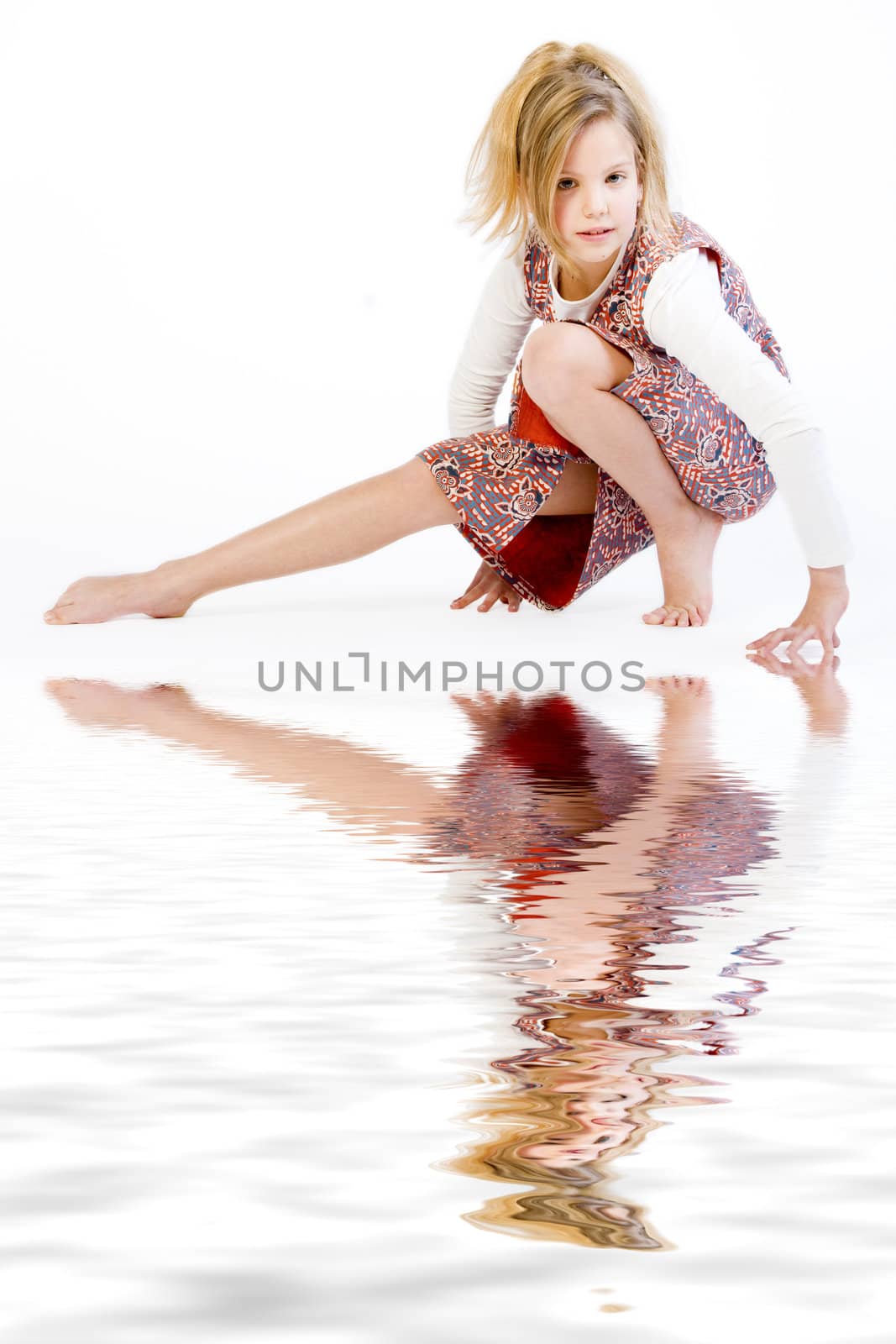 Studio portrait of a blond child stretching