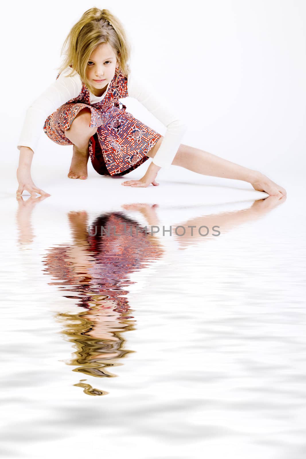 Studio portrait of a blond child stretching