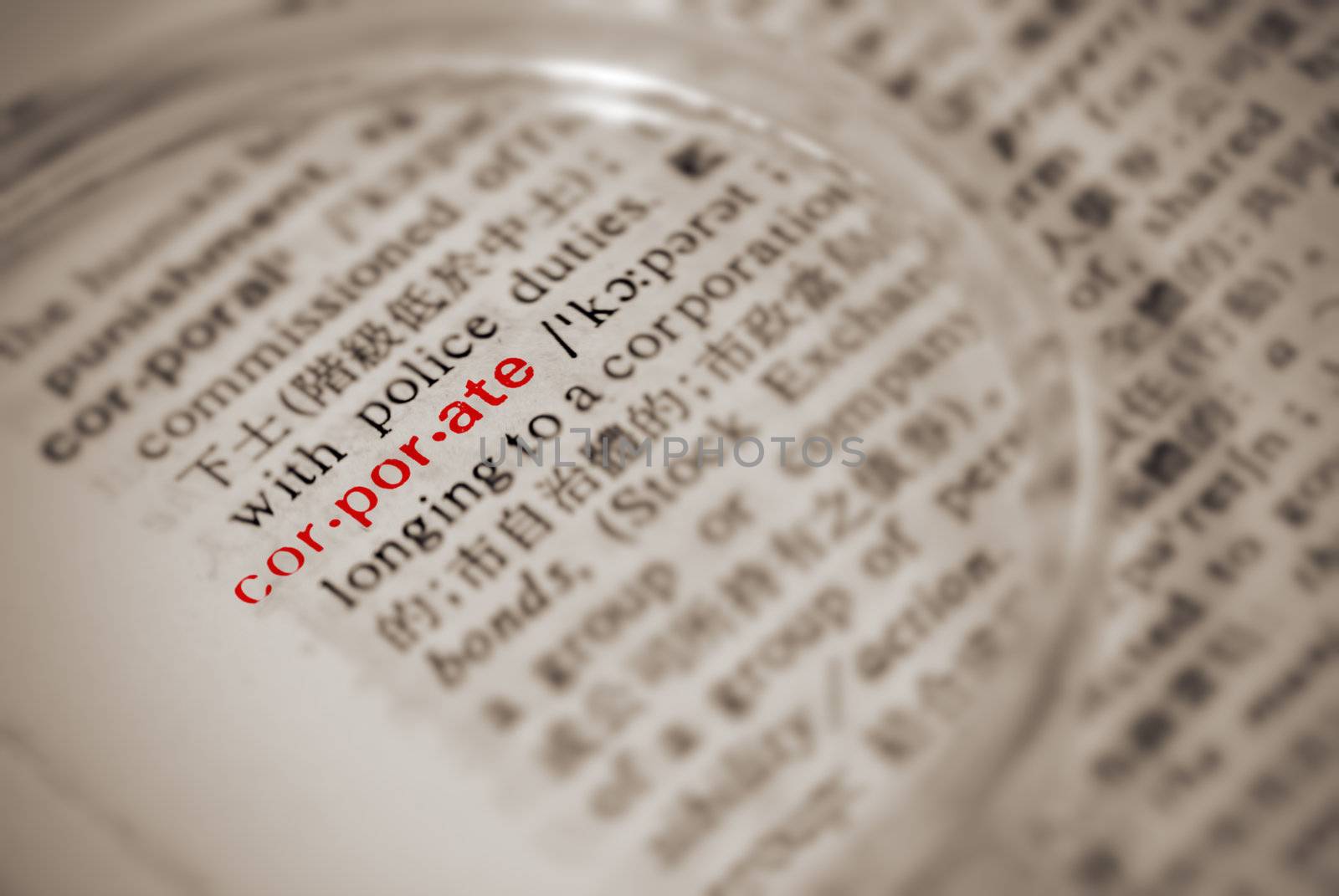 Corporate definition in dictionary with magnifier in yellow color.