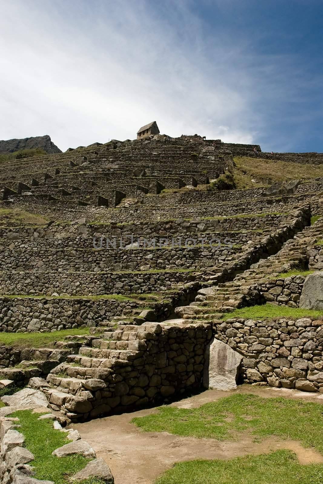 Machu Picchu  is a pre-Columbian Inca site located 2,400 meters (7,875 ft) above sea level. It is situated on a mountain ridge above the Urubamba Valley in Peru, which is 80 km (50 mi) northwest of Cusco. Often referred to as "The Lost City of the Incas", Machu Picchu is probably the most familiar symbol of the Inca Empire.