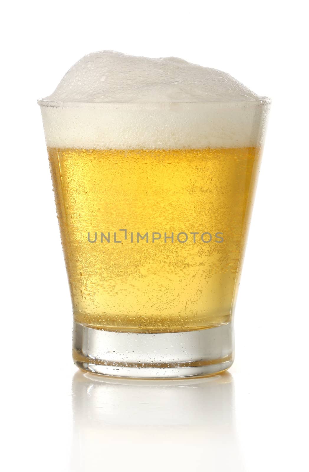 Glass of cold and fresh golden beer, over white background