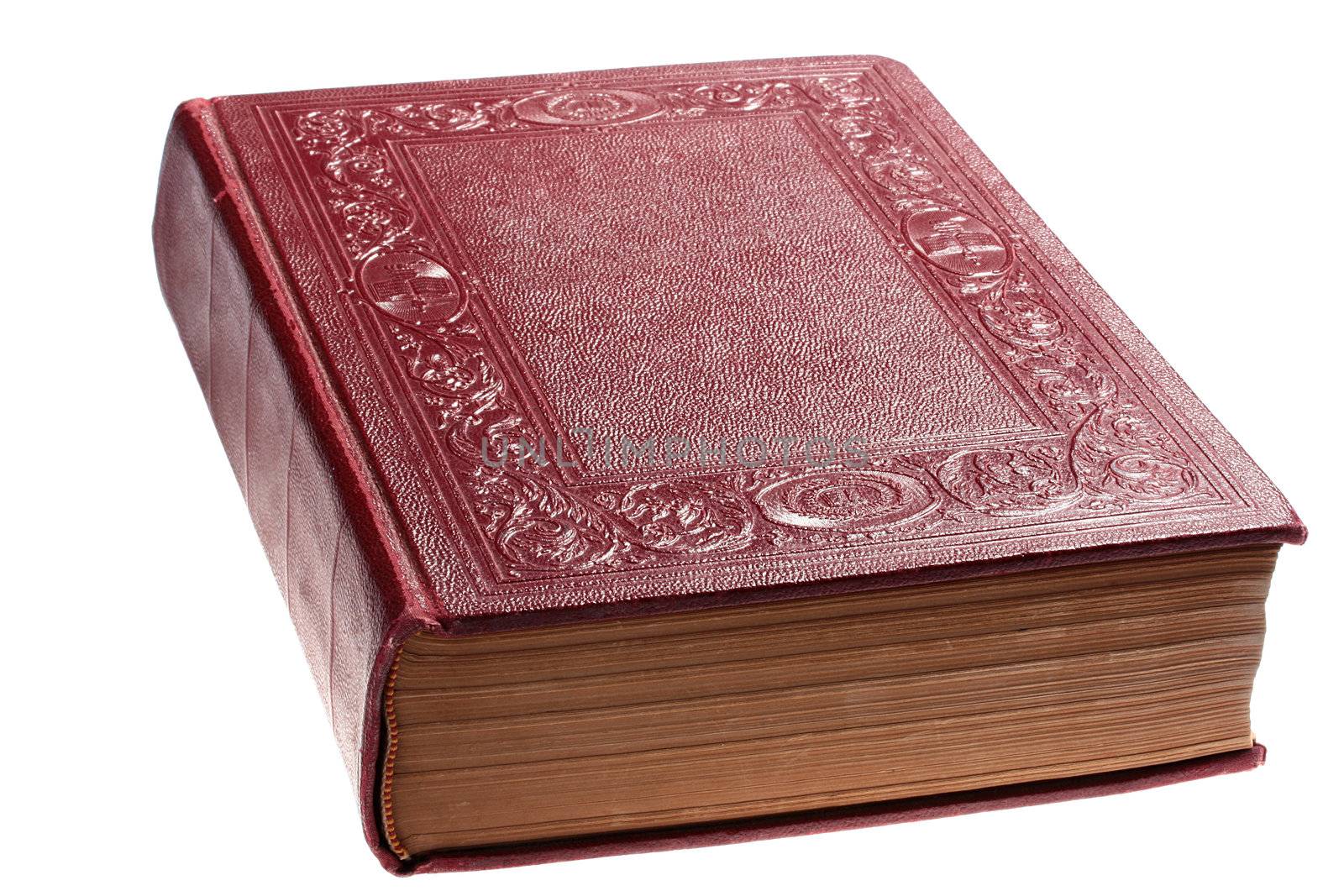 The ancient closed book in darkly red cover on a white background.