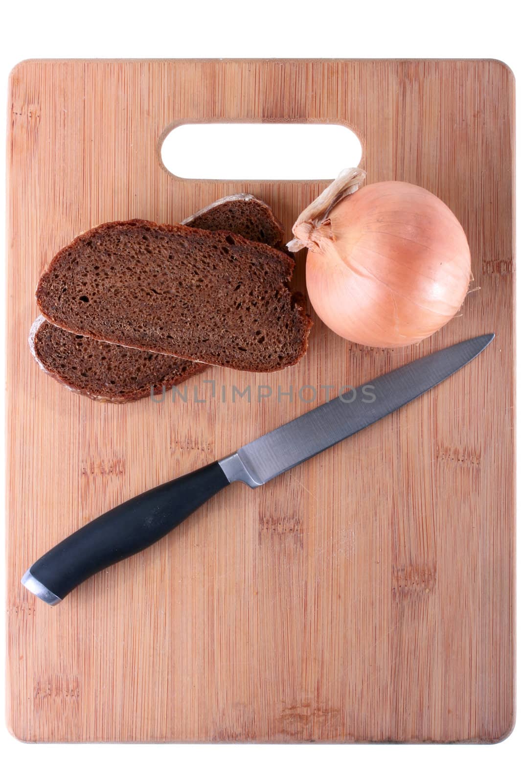 Two slices of black bread, bulb and knife on a finishing kitchen board. Products are placed so that the designer could make an inscription.