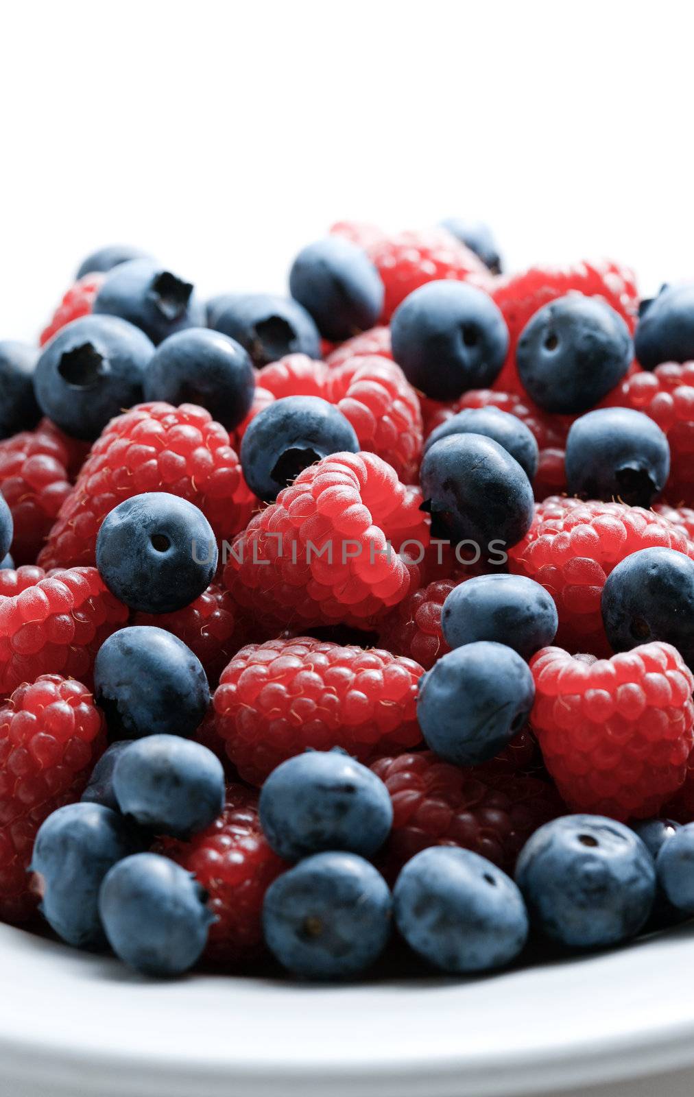 Close up of mixed berries in a bowl - shot in studio