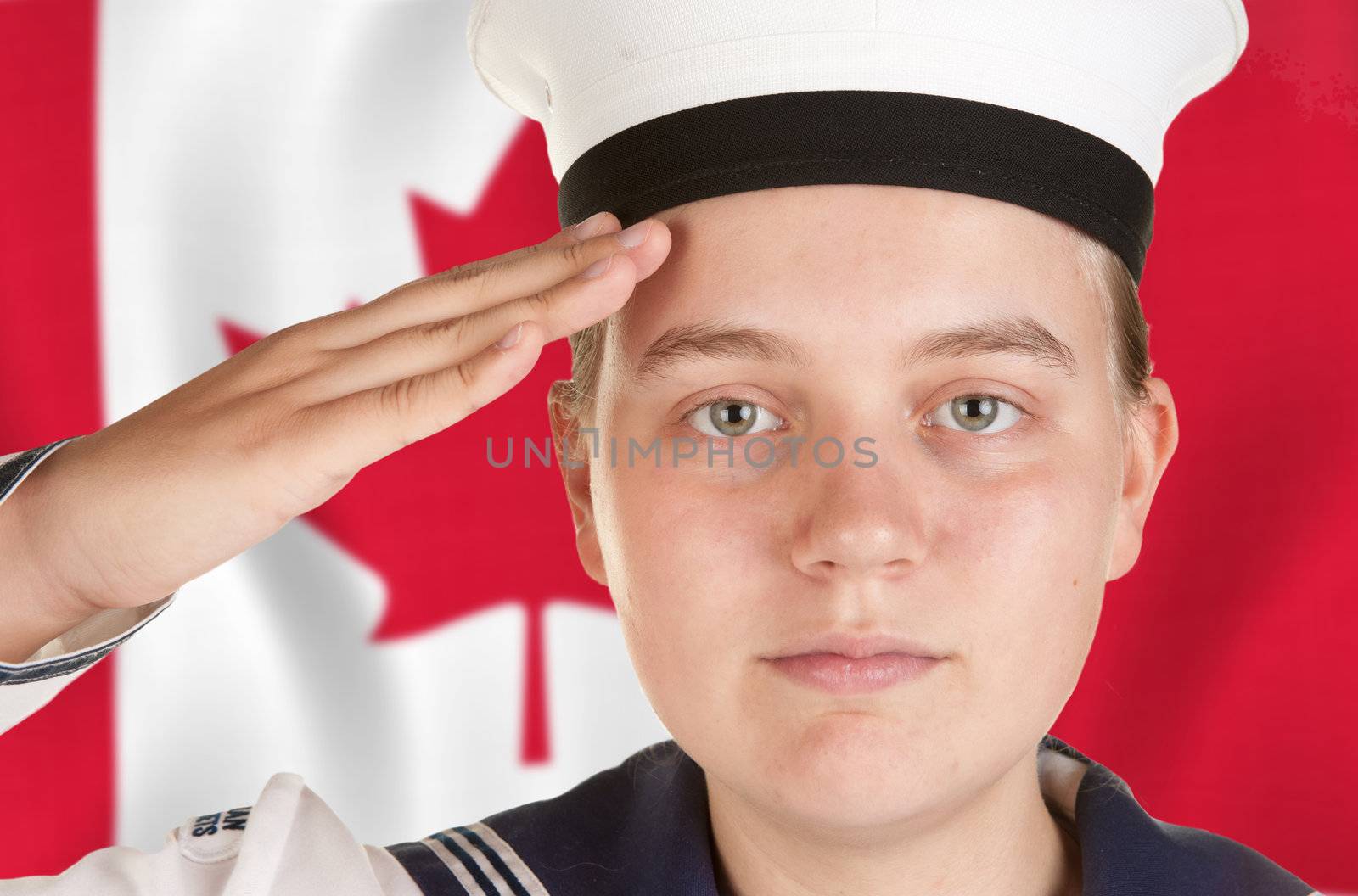 young female sailor saluting in front of canadian flag