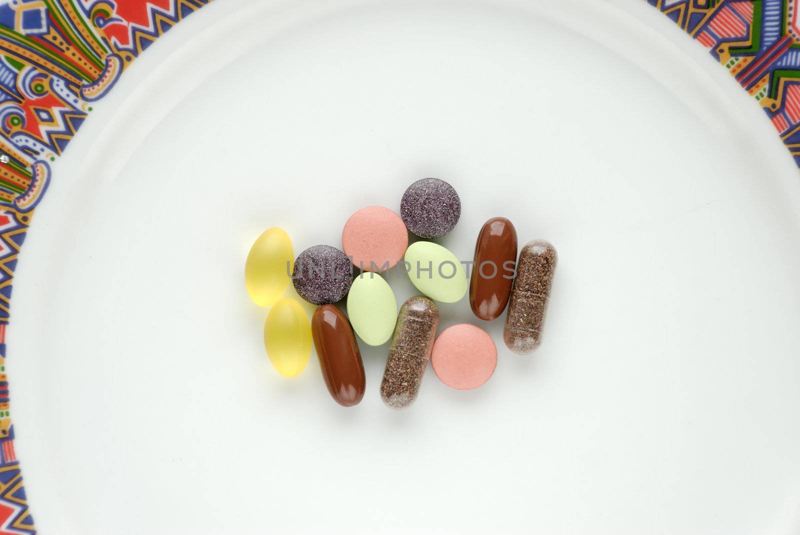 A dose of vitamins and minerals on a plate. Seen from above.
