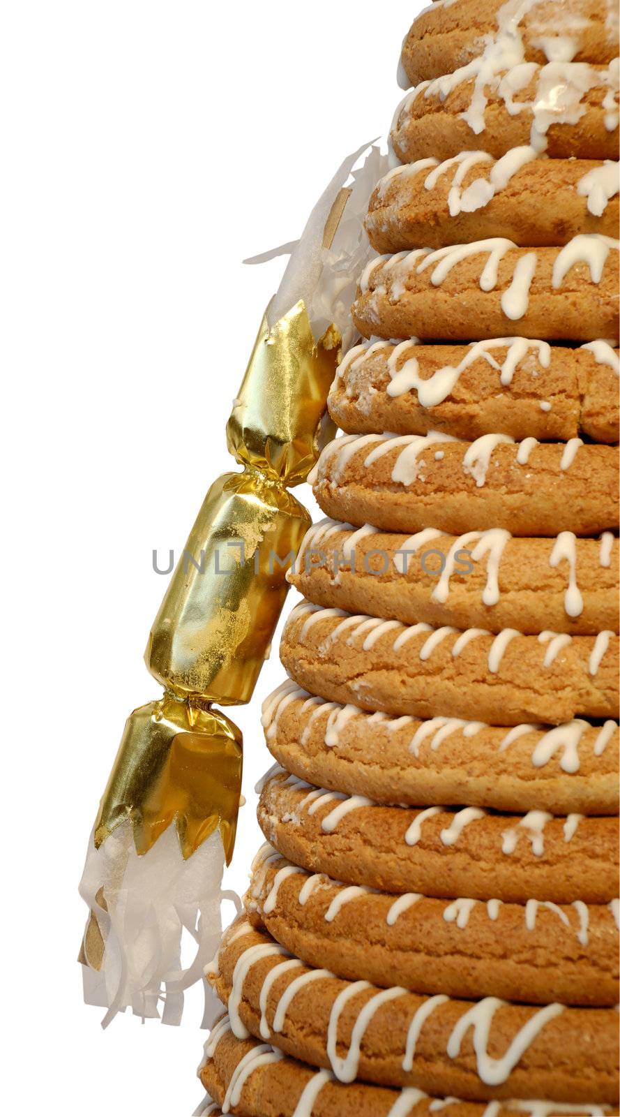 Traditional Norwegian marzipan ring cake - kransekake - seen from side with cracker. Isolated with clipping path.
