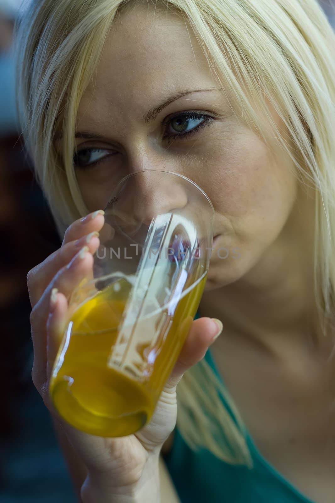 Young woman relaxing with a beer at a bar